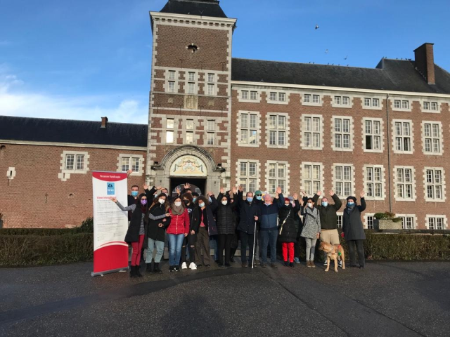 Participants of the training course "More opportunities for adapted ESC for young VIP (visually impaired people)" pose for a picture in front of the castle of Wegimon (Belgium)