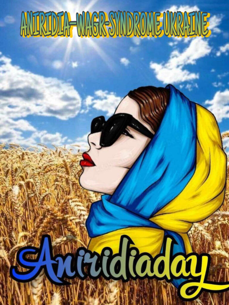 A girl with sunglasses in a wheat field wearing a yellow-blue scarf